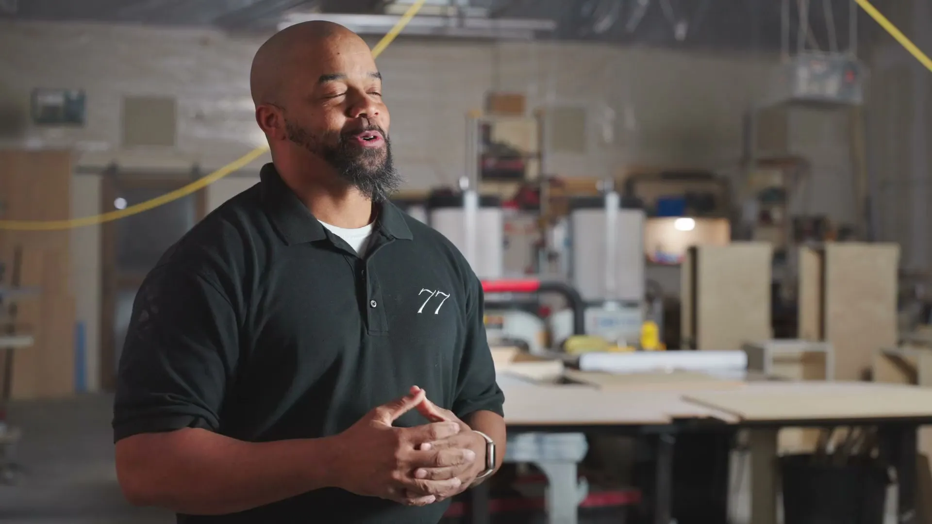 Farmhouse77's founder speaking in the cabinetry workshop
