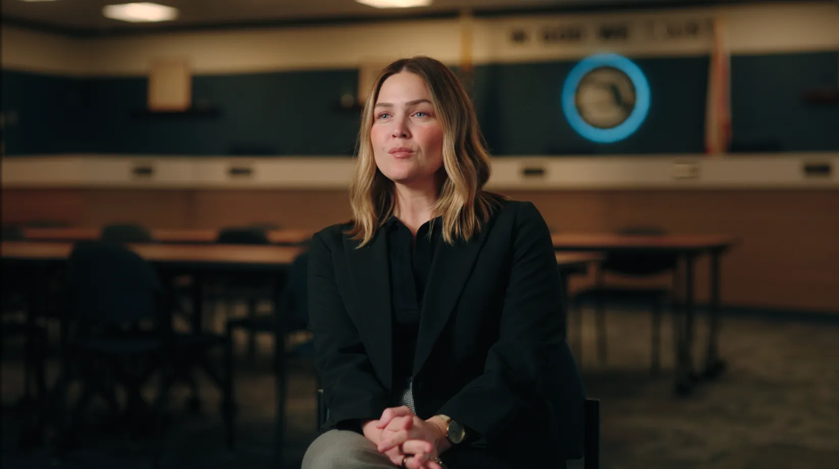 School administrator seated for an interview in a district board room